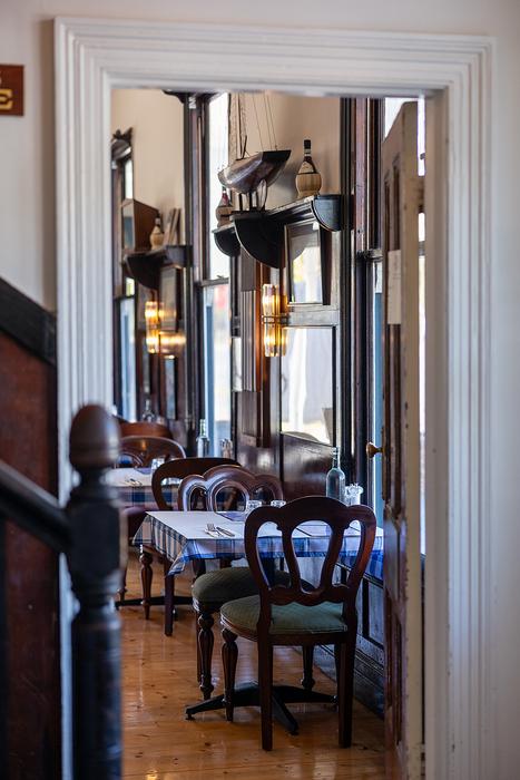 Lido Cucina restaurant interior with vintage boat and heritage bar