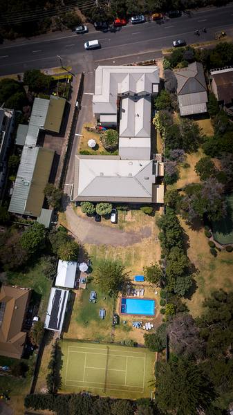 Aerial view of the full property, pool and tennis court