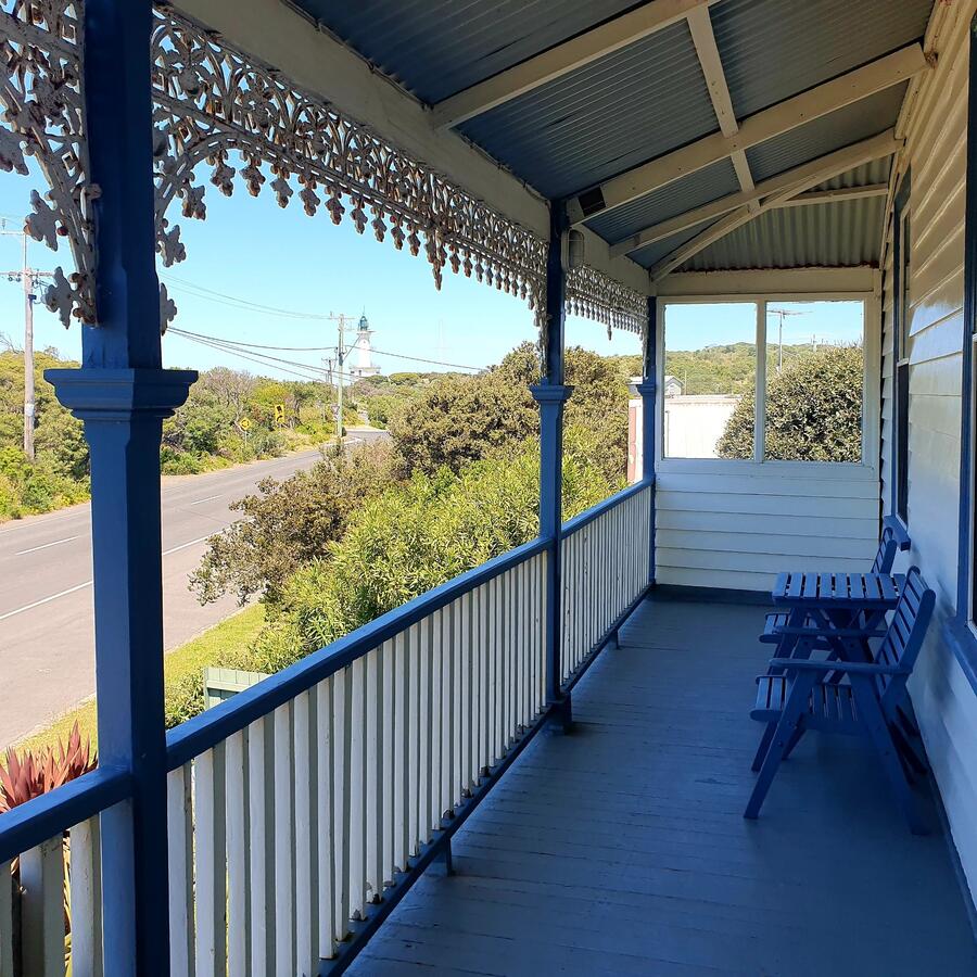Heritage verandah with ornate ironwork and lighthouse views