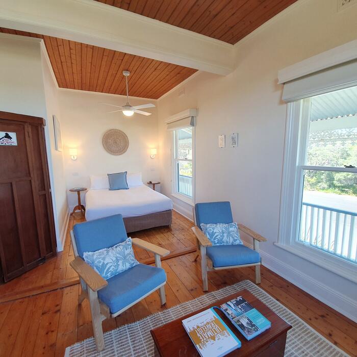 Charming guest room with timber ceiling and coastal furnishings